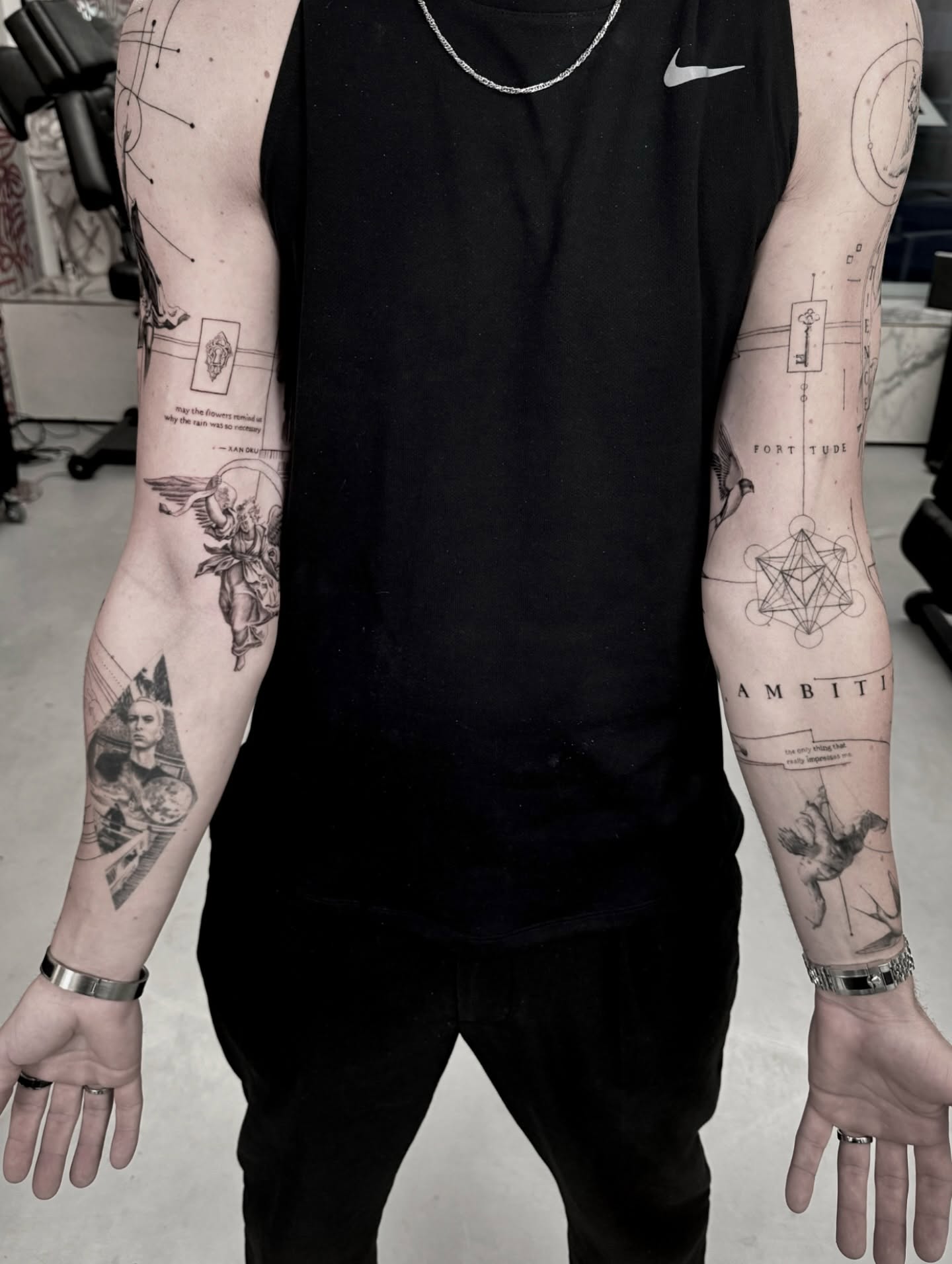 Front-facing body context with the documented project visible across shoulder and arm