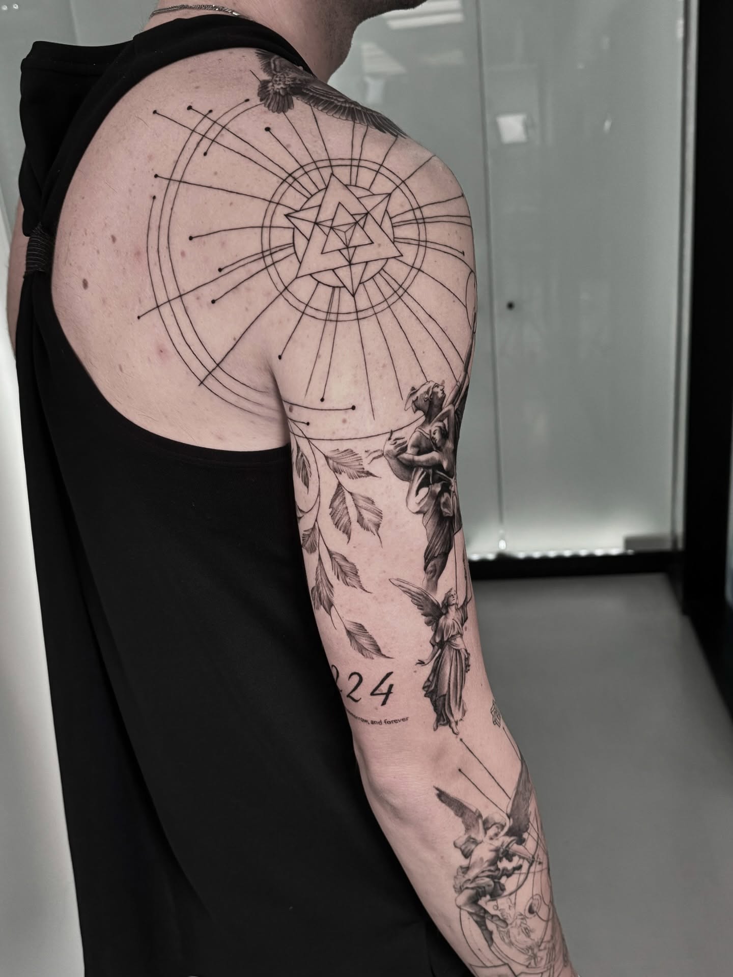 View from behind of shoulder and arm with the geometric anchor and the direction down toward the elbow
